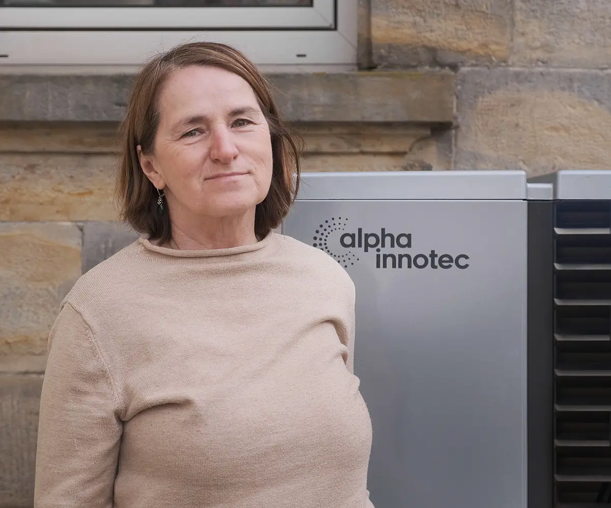 Owner of a farmhouse shows her heat pump