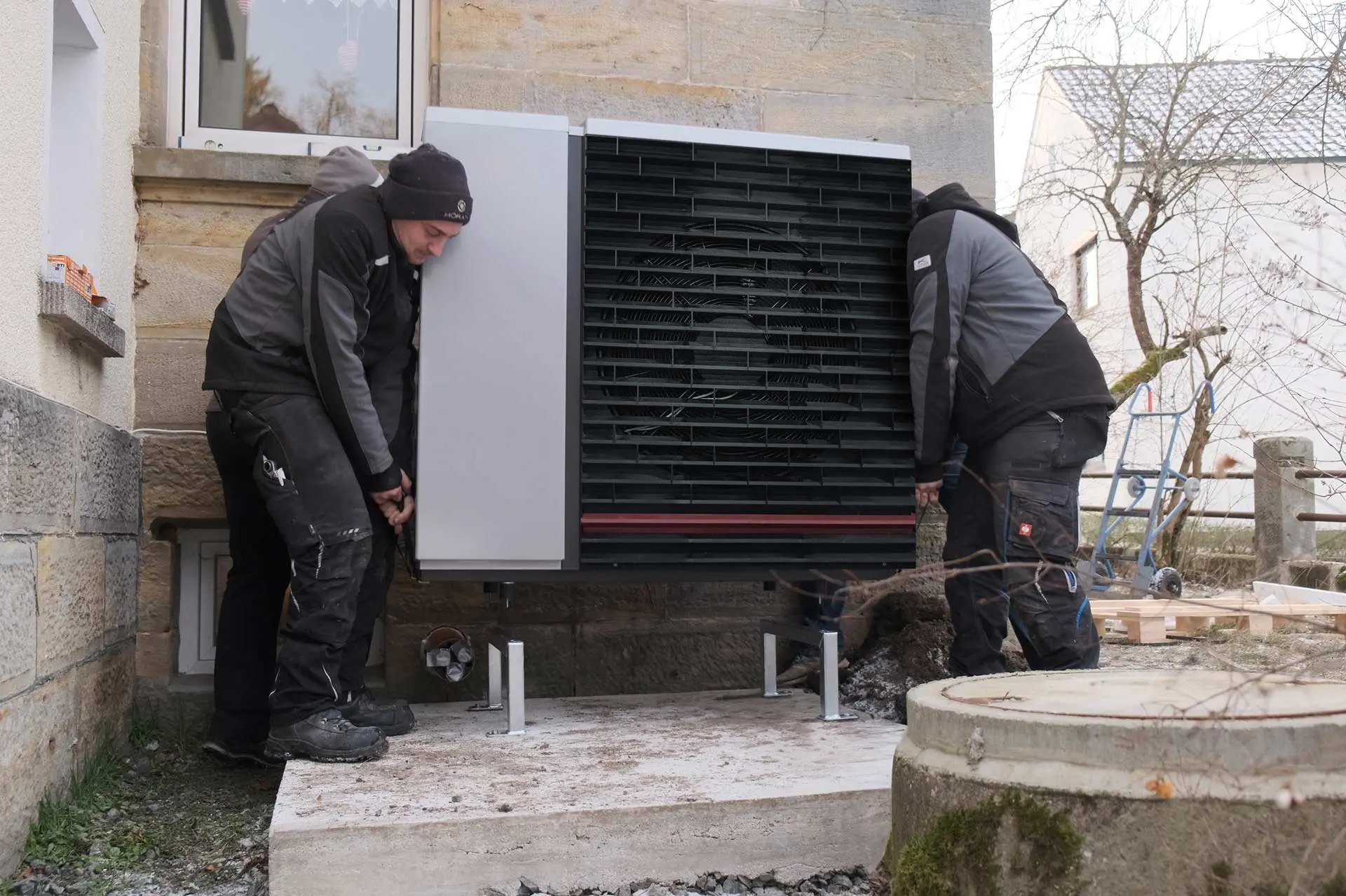 An old heating system is replaced by two installers with a Hybrox air source heat pump from alpha innotec