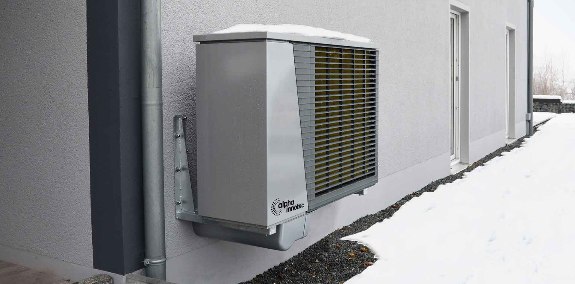 The heat pump LWD is shown diagonally from the left on a house wall