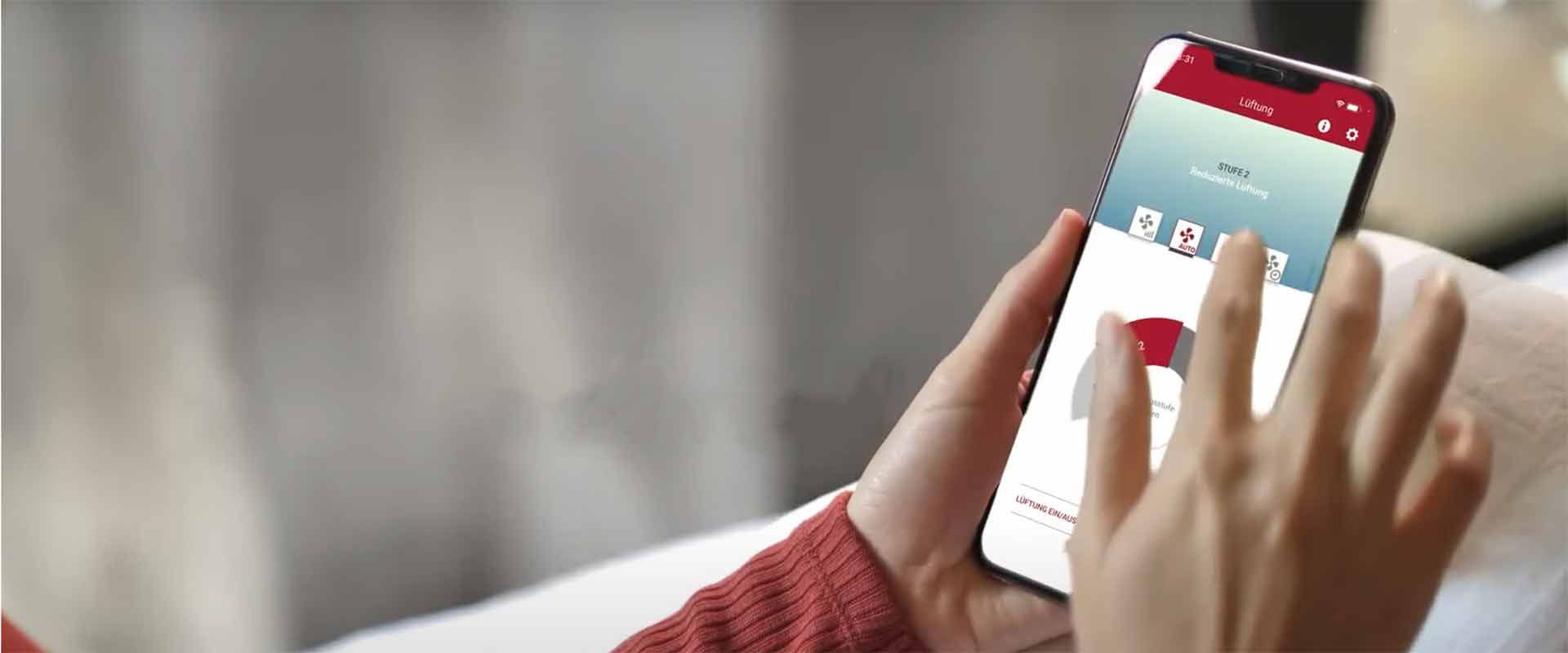 In close-up, a woman's hands are seen typing on the alpha app via mobile phone as she changes settings of the heat pump.